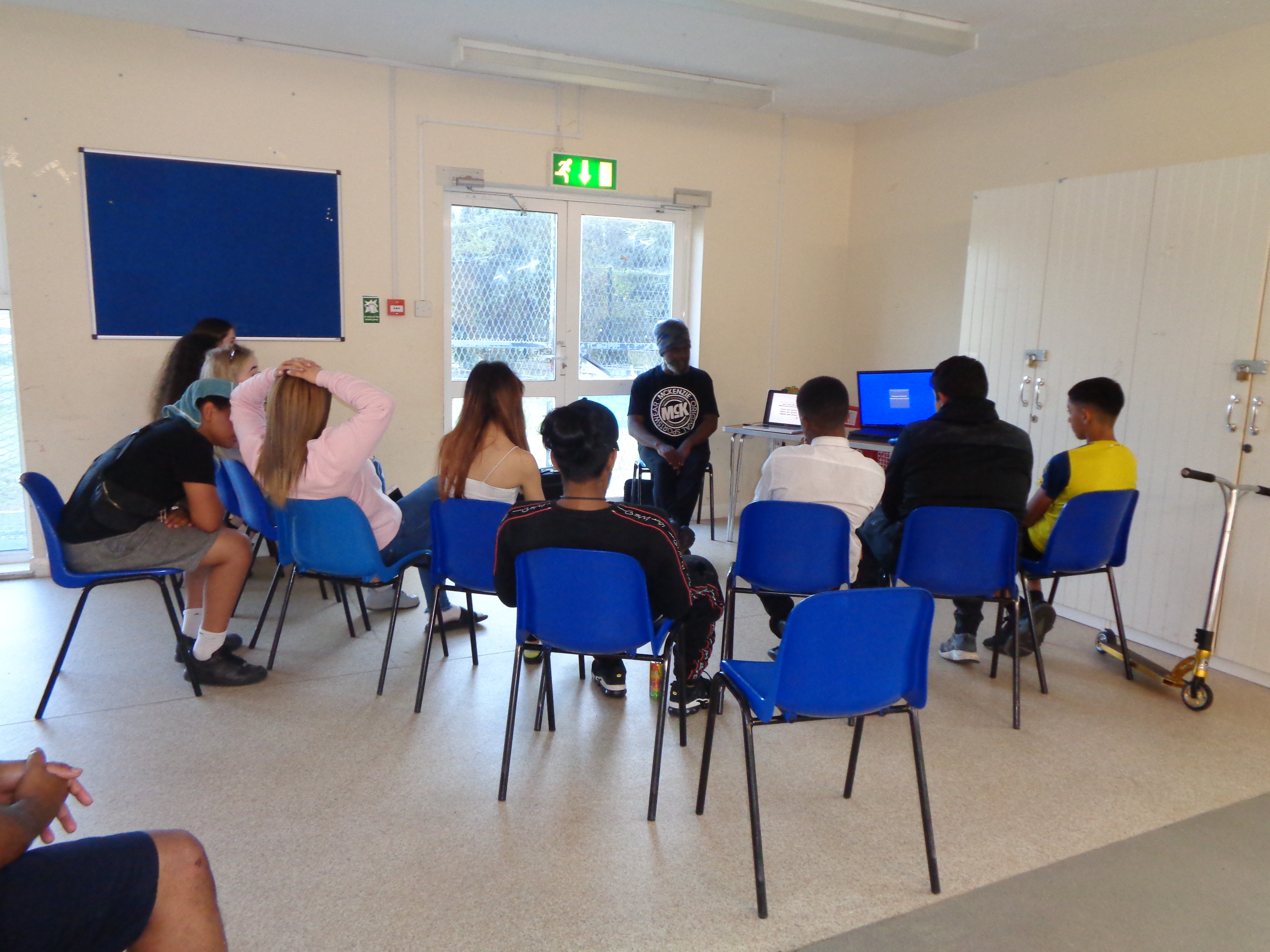 Tutor speaking to the young people 